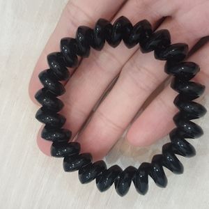 Elastic spring round hair tie made of flexible plastic